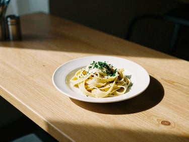 A cozy Scandinavian-style bistro table with a single plate of fresh pasta, soft natural side-light, high-contrast shadows, 35mm film.