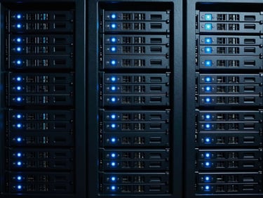 Server arrays with cold blue indicators, symmetrical framing, dark slate tones, high-density terminal aesthetic, cold cinematic photography.