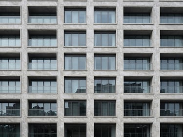 Symmetric modern building facade made of light grey natural stone and glass, clean lines, balanced architectural composition