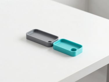 Minimalist product shot of sleek 3D printed office accessories in cool grey and turquoise tones on a pristine white desk