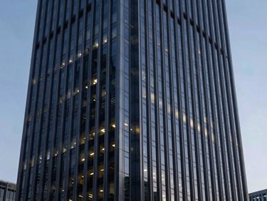 Cinematic wide shot of a modern corporate skyscraper facade at dusk, cool architectural lighting with subtle blue highlights, sharp focus, 35mm