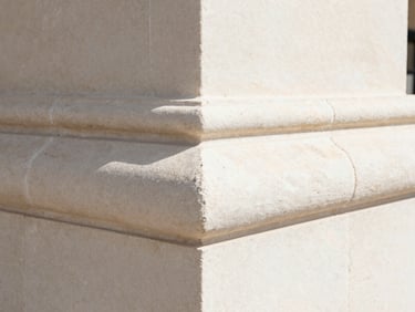 Extreme close-up of flawless mitered stone corners and perfectly aligned grout lines, crisp detail, bright natural morning light