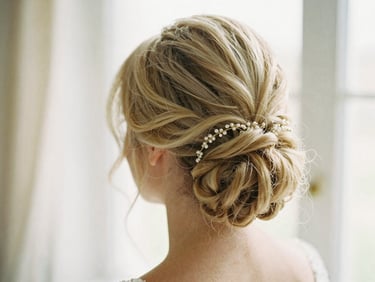 Elegant bridal updo, soft focus on intricate details, warm studio light, 35mm.