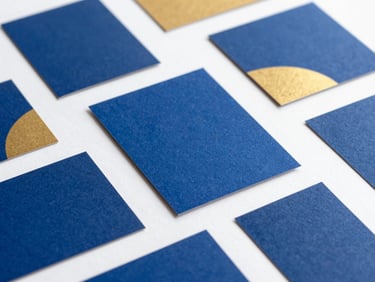 A collection of high-end branding mood boards with royal blue and gold color swatches, elegant typography cards, editorial layout