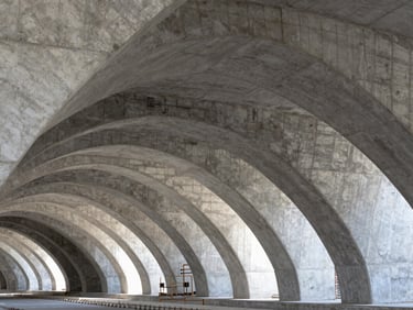 Wide-angle view of a modern metro tunnel under construction, high-contrast structural concrete arches