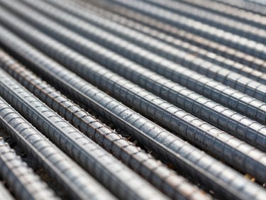 Macro shot of GFRP rebar rib profiles with saltwater spray, crisp industrial focus