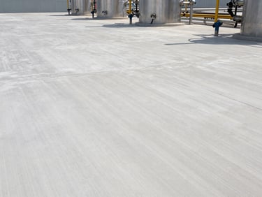 Crisp daylight shot of industrial flooring in a chemical processing plant, clean modern concrete slabs