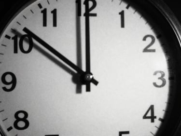 Abstract black and white photo of a broken clock face, long shadows, surrealist composition, 35mm lens.