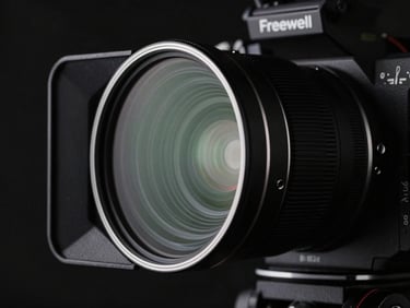 High-end cinema camera with a Freewell filter mounted, low-key dramatic studio lighting, sharp focus on the filter.
