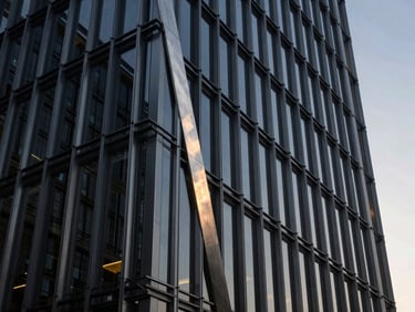 A towering 8-meter totem sign at a modern corporate headquarters, steel construction, sharp architectural angle, daylight