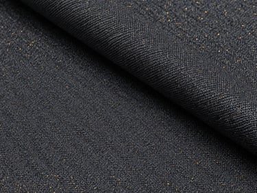 Close-up of a blended textile bolt, showing a rich charcoal-grey weave with subtle gold thread accents, luxury editorial style.