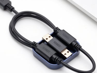 Close-up of a sleek magnetic cable organizer holding multiple black USB cords on a clean desk surface, bright lighting