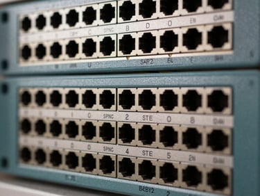 Close macro shot of a high-density fiber patch panel front face, labeled ports in rows, even studio lighting, sharp focus on connector alignment and labeling detail