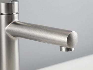 Macro detail of high-end brushed steel mixer tap, neutral studio lighting, architectural focus