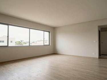 Interior living room of a Brazilian apartment, wide shot showing full room scale, natural light from large windows, neutral walls and floor, no furniture staging