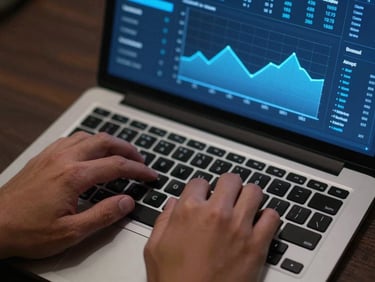 Close-up overhead view of hands on a laptop keyboard in a dark office, an analytics dashboard visible on screen showing ad spend and conversion graphs in electric blue on dark background, cool LED light from the screen illuminating the fingers