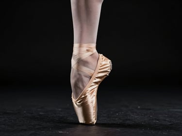 High-contrast studio photograph of a pointe shoe undergoing mechanical stress analysis, soft dramatic side-lighting, deep black background, focusing on the flexed sole and gold detailing, 85mm lens