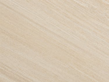 Overhead macro of Travertino Classico slab — warm ivory with characteristic pore structure and linear banding, studio strobe overhead, tight orthographic crop