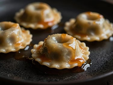 Macro shot of house-rolled lobster ravioli with a glossy cognac reduction, low-key dramatic side lighting, 35mm