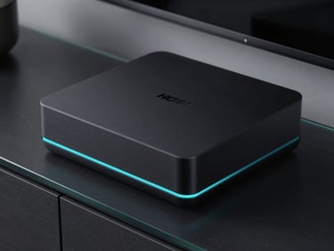 Extreme close-up of a sleek, matte black streaming box with a subtle glowing cyan LED strip on the front, sitting on a dark glass media console.