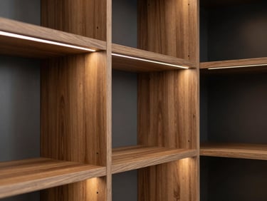 Minimalist wardrobe closet with open walnut shelving, integrated LED lighting strips, architectural alignment