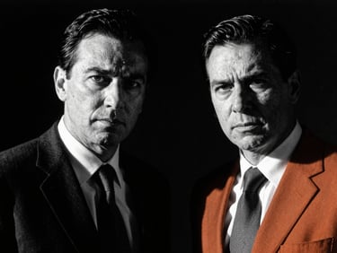 Stark editorial portrait of two business partners in high-contrast black and white, dramatic side-lighting, intense facial expressions, 35mm film grain