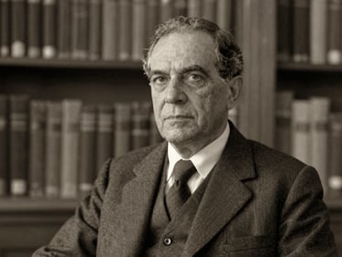 Archival sepia-toned portrait of a distinguished Brazilian academic, Dr. Carlos Almeida, in a scholarly setting, soft natural library light, matte texture, historical archival feel, 35mm.