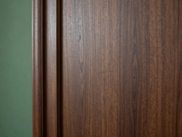 Close-up of dark walnut wood panel texture, elegant side-light, rich deep tones, architectural detail