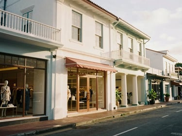 Charming street in Saint Barth with luxury boutiques, classic Caribbean architecture, warm natural light, 35mm, no people.