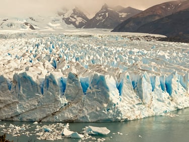 Expansive natural landscape of the Perito Moreno Glacier in Patagonia, Argentina, with dramatic ice formations, soft daylight.
