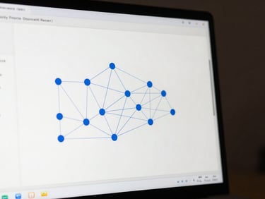 Close-up of a software dashboard on a monitor showing neural network architecture visualization with nodes connected by thin blue lines, clean white background.