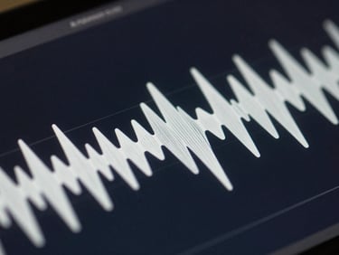 Macro screenshot of acoustic wave propagation simulation, clean sinusoidal wave patterns radiating from a point source on a dark screen.