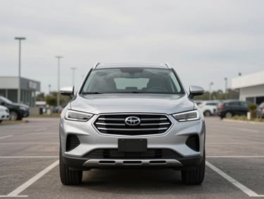 Head-on shot of a silver SUV parked on a clean dealer lot under overcast daylight, full front fascia visible, empty lot, neutral sky