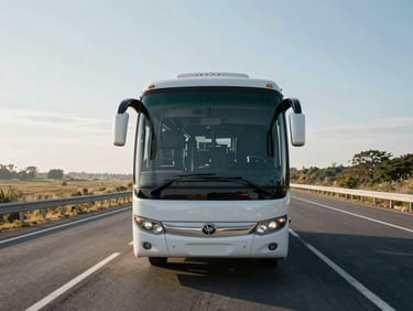 Front view of a luxury tourist coach parked on a wide scenic highway, spotless exterior, bright morning sun.