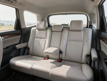 Bright interior of a Toyota Innova Crysta, spotless leather seats, ample legroom, clear morning light filtering through clean windows.