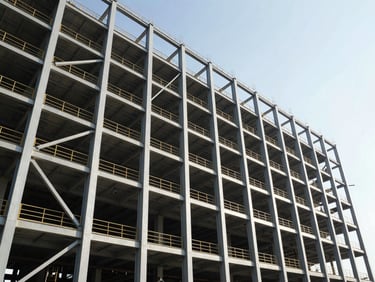 Massive steel framework of an industrial plant under construction, high-contrast daylight, dramatic low-angle shot emphasizing height and scale