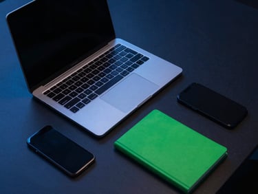 Overhead view of a sleek productivity-focused desk setup with a laptop, notebook, and smartphone, cool blue ambient light, sharp focus.