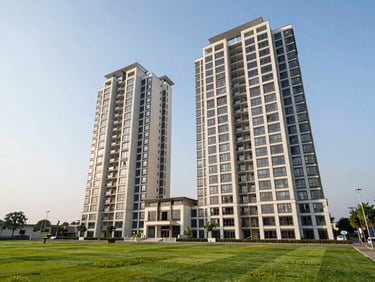Modern apartment towers of Amrapali Dream Valley with green landscaped lawns, bright daytime lighting