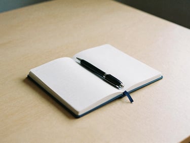 Minimalist clean desk setup with a notebook and a high-end pen, soft overcast light, warm sand tones, 35mm film