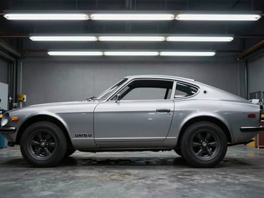 Straight-on side profile of a stripped 1972 Datsun 240Z steel body on a jig, overhead fluorescent lighting, sharp industrial photography, 35mm