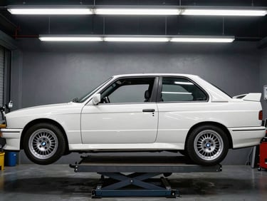 Straight-on side profile of a white BMW E30 M3 chassis on a rotisserie, harsh workshop lighting, high-contrast metallic tones, 35mm