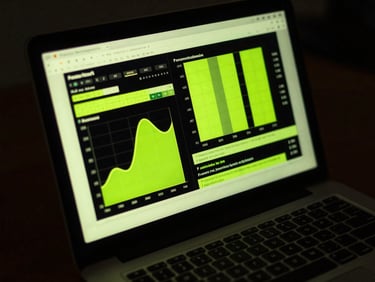 Close-up of a laptop screen displaying high-contrast conversion charts, electric lime glow, dark workspace environment