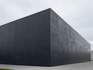 Minimalist architectural photography of a modern automated logistics warehouse exterior, stark concrete lines, overcast sky, 35mm