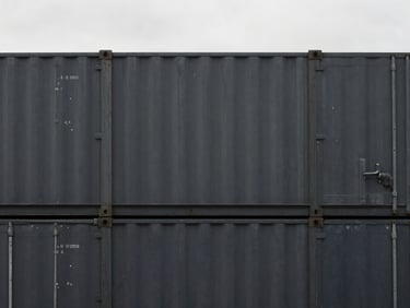 Minimalist architectural photography of a container terminal, overcast daylight, sharp focus, deep charcoal tones, 35mm