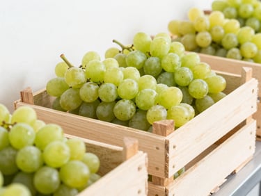 A crisp close-up of export-grade table grapes packed neatly in clean modern wooden crates inside a bright temperature-controlled cold storage facility, high-key daylight