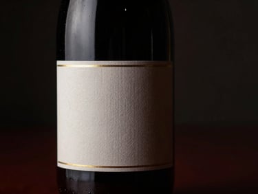 Close-up of a unique wine bottle with a textured label, shallow depth of field, single-source side lighting, brushed champagne gold reflections