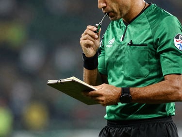 A referee holding a whistle and notebook, high-contrast sports editorial style