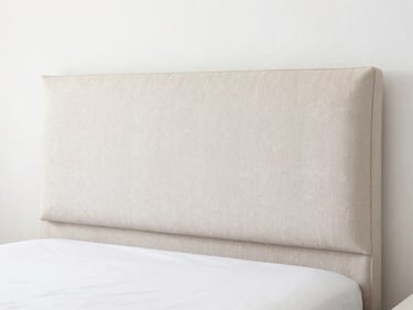 Upholstered bed headboard being deep cleaned, fresh bedroom atmosphere