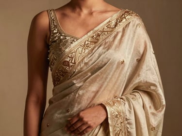 Close-up of a luxurious silk saree with intricate embroidery, draped on a modern Indian model, diffused studio lighting, shallow depth of field