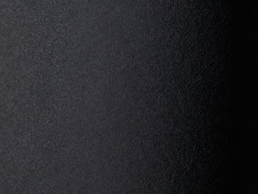 Macro close-up studio shot of dark grey Alcantara fabric texture, soft matte finish, emphasizing tactile feel, moody lighting, 50mm